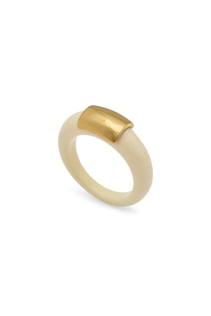 Ivory resin ring with a gold metal accent on a white background