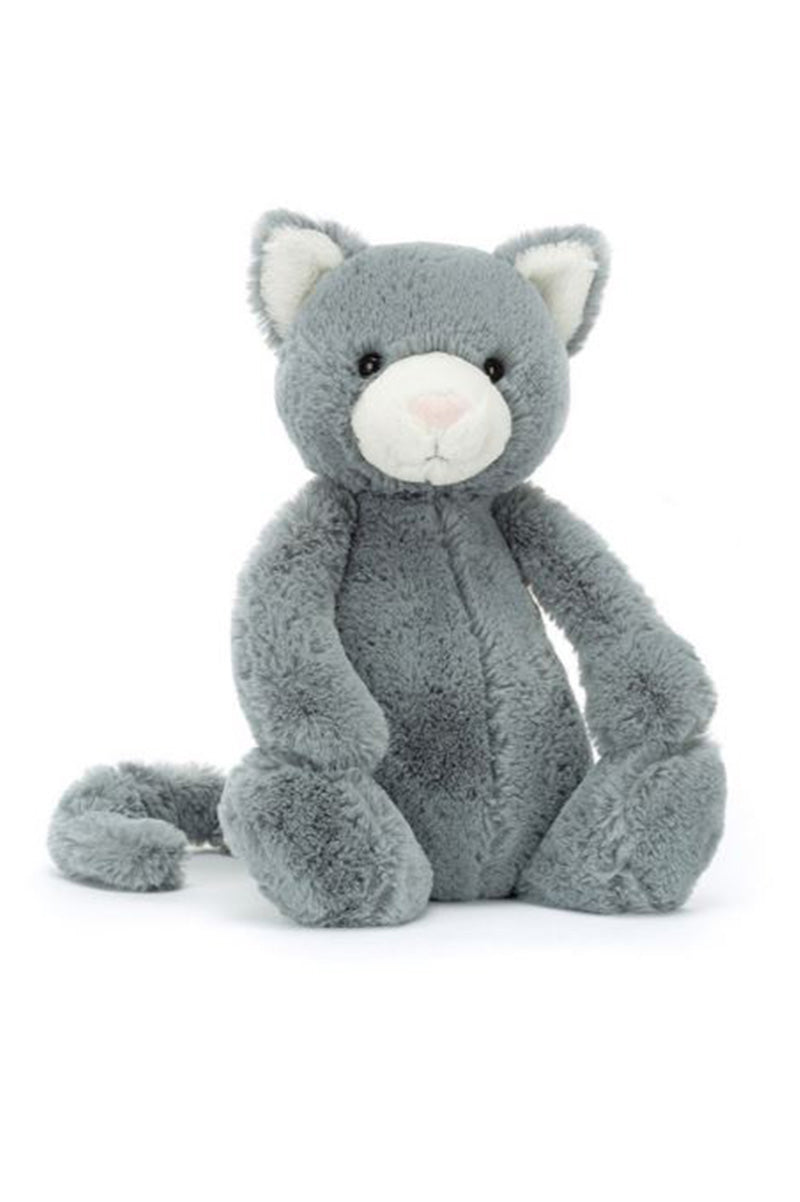 Medium stuffed kitten in grey with white muzzle, sitting with paws forward