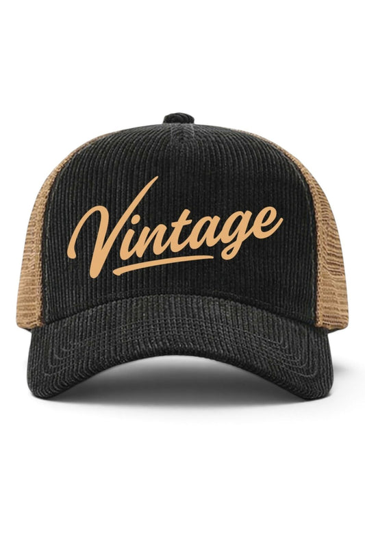 A black corduroy trucker hat with tan mesh back panels and a gold embroidered script reading 'Vintage' on the front, shown against a plain white background.