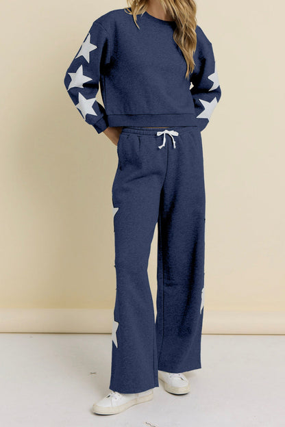 Navy terry wide-leg pants with drawstring waist and star prints