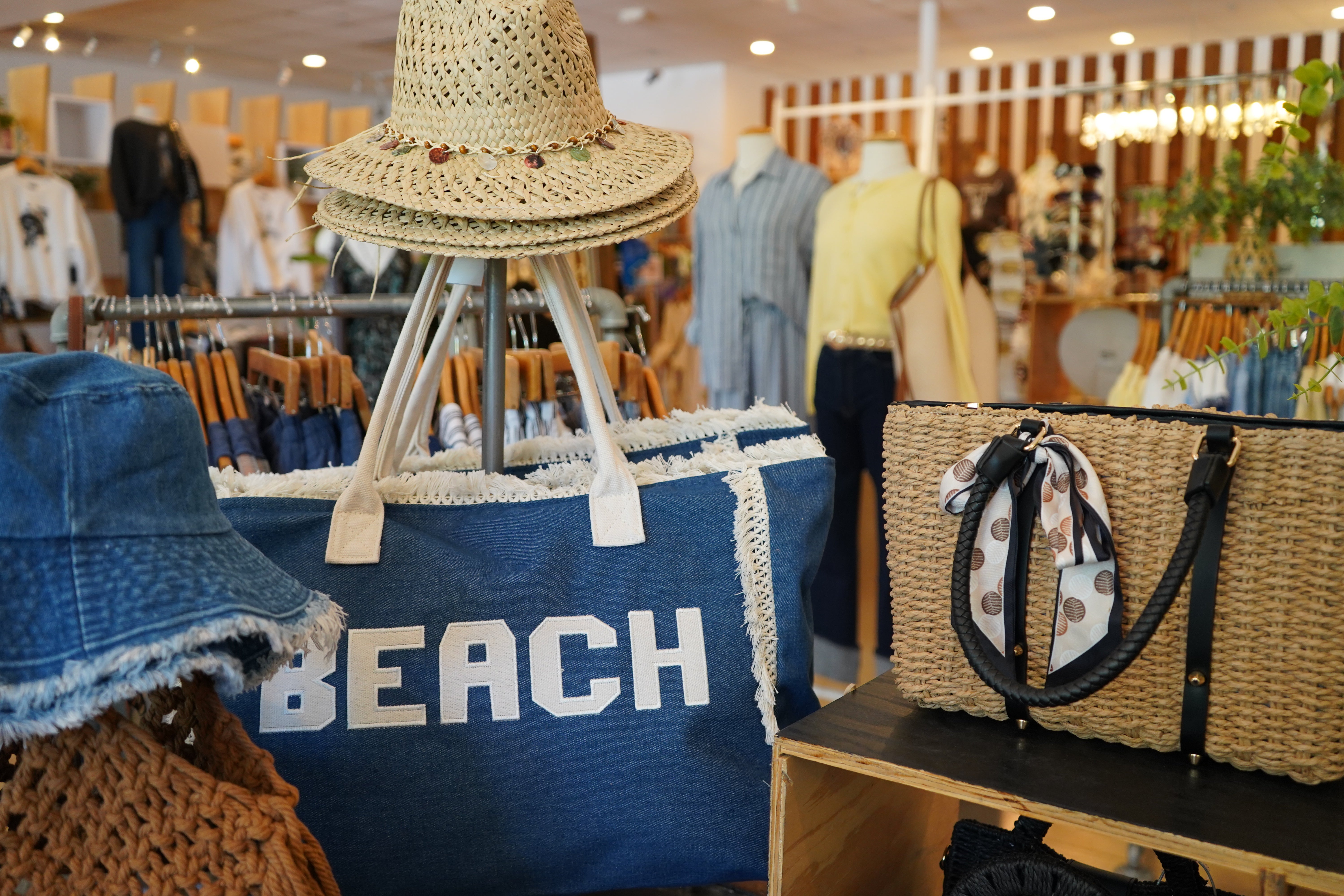 A display of beach totes and sun hats.