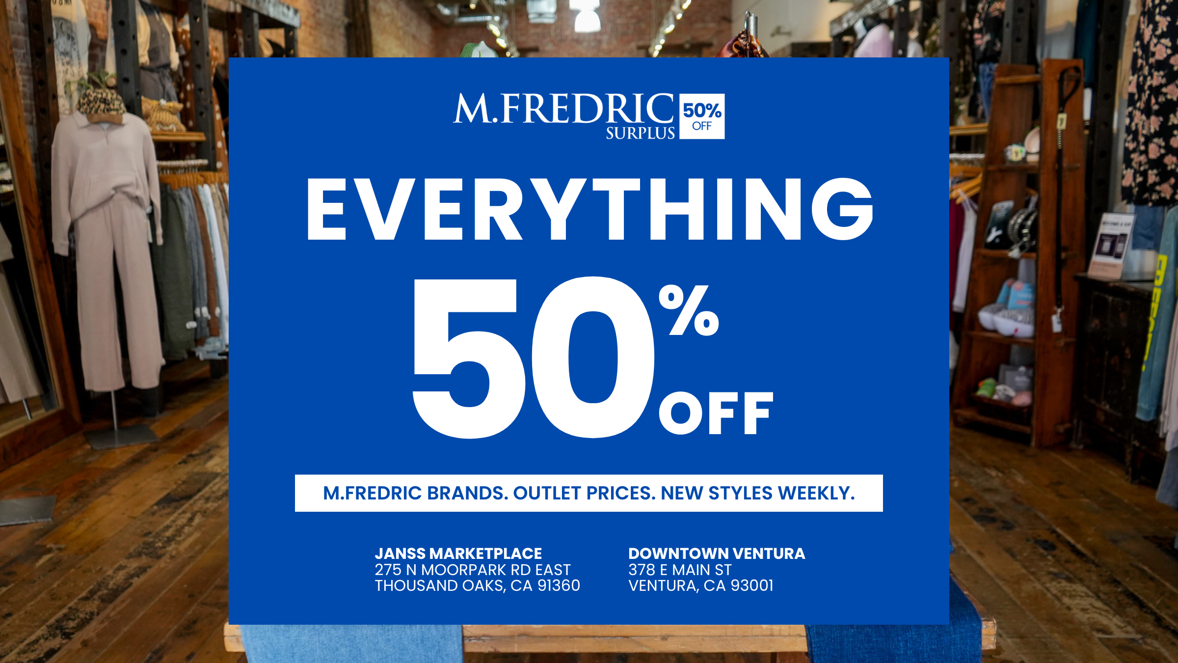 Promotional sign for M.Fredric Surplus stores with 50% off in a clothing store.