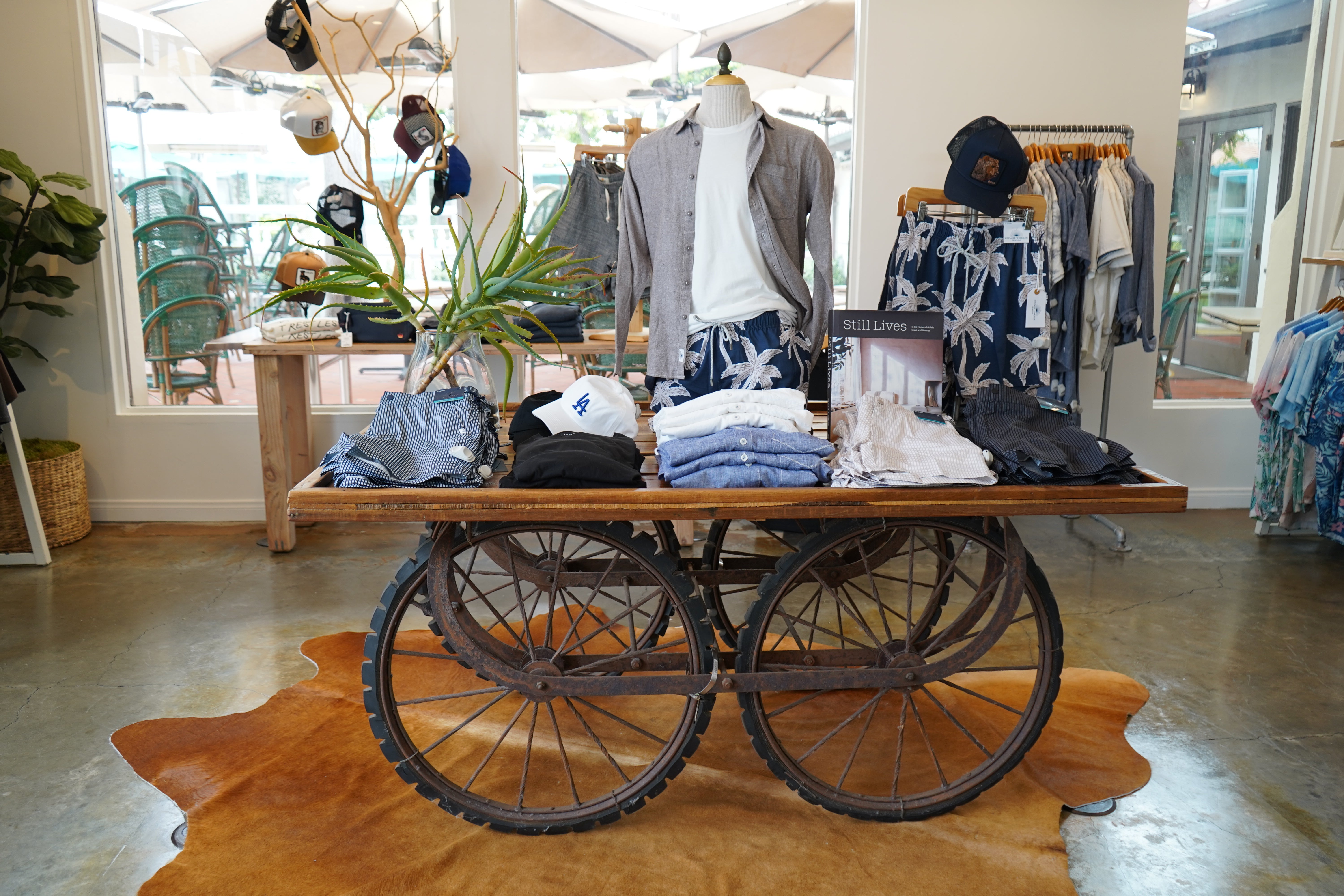 Vintage cart with clothing displayed in a store setting