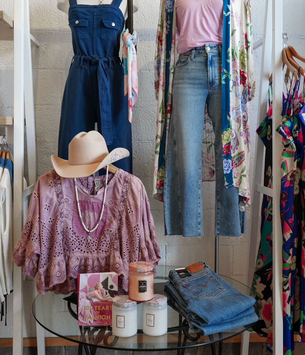 Boutique table with clothing, accessories and candles