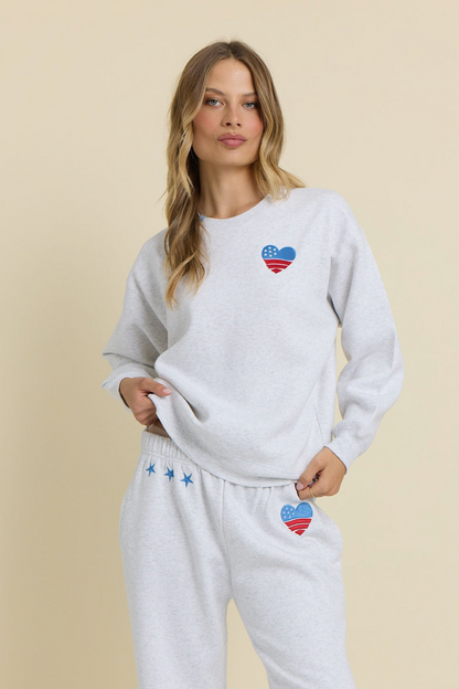 Ash grey embroidered crewneck sweatshirt with matching sweatpants, front heart and stars logo