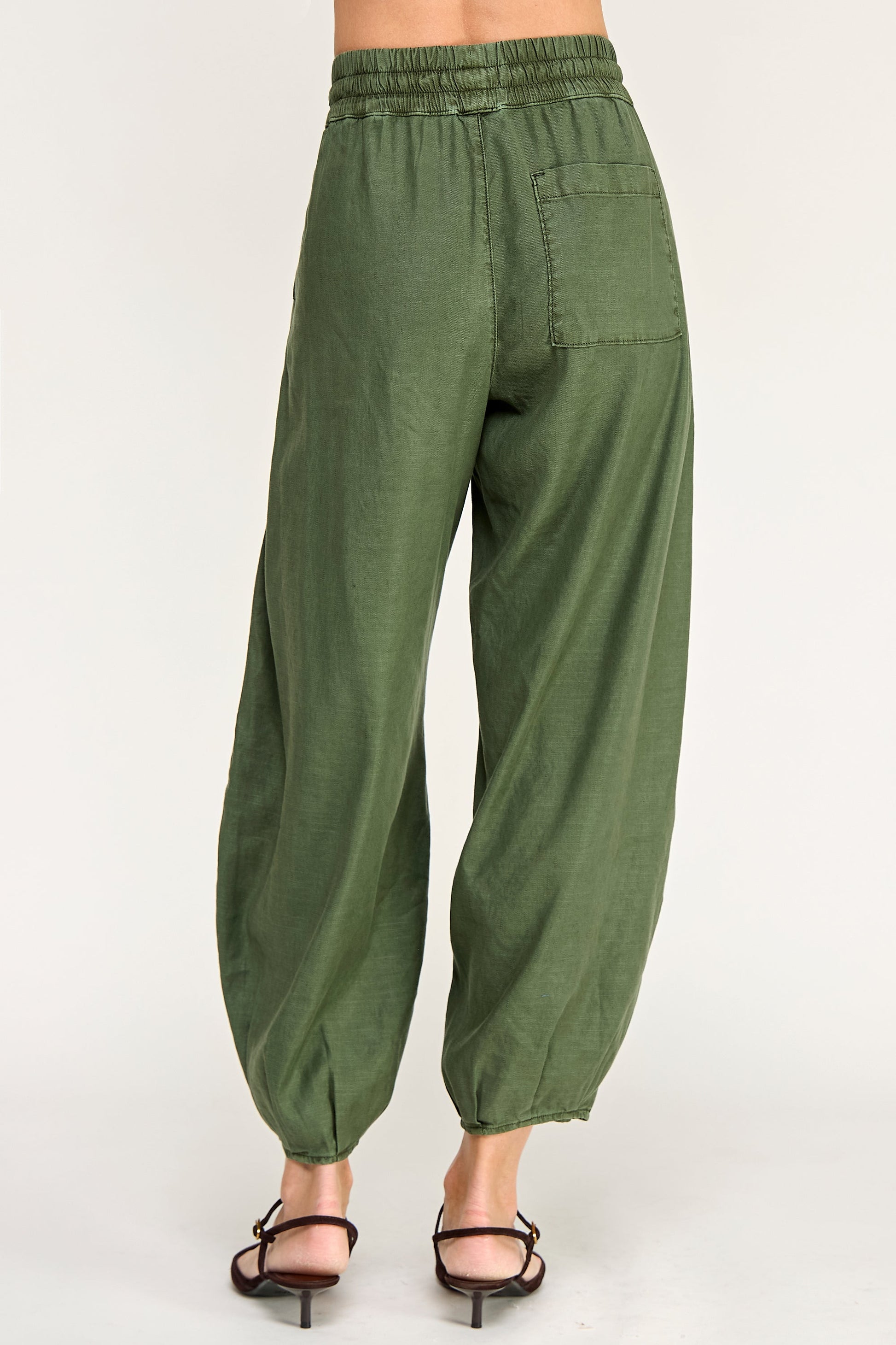 Back view of person wearing ellie mini pull on balloon pants in avocado green